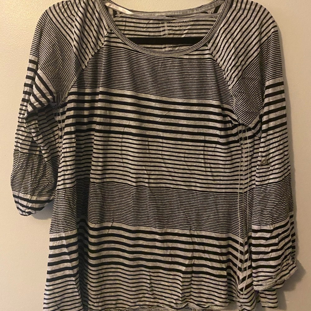 Two Calvin Klein performance shirts